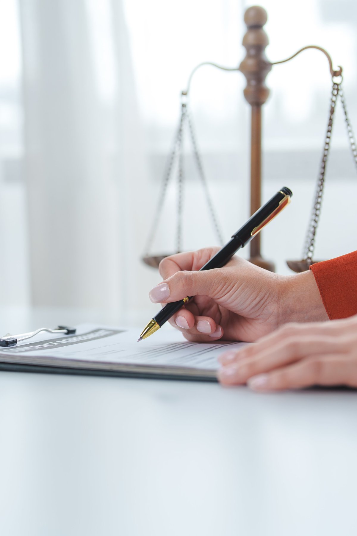 Attorney reviewing legal documents with scales of justice in the background