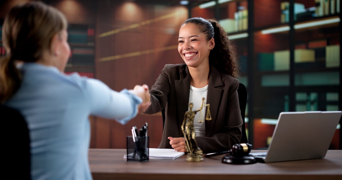 Attorney and client shaking hands after an educational consultation